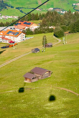 Alpine summer aerial view with cable car gondula shadows at Mount Sechszeiger, Pitztal valley, Jerzens, Imst, Tyrol, Austria