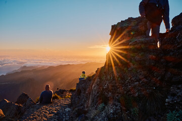 silhouette of a person on a rock in the mountains at sunrise in Madeira, Portugal