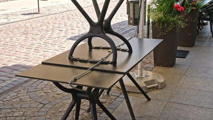 Outdoor Tables Secured with Metal Steel Cable and Padlock Infront of Boulveard Pub Cafe Coffee Shop...