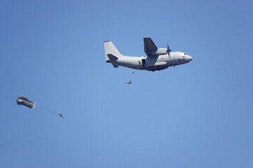 sky divers from military plane