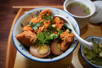 Taiwanese braised pork rice with salted crispy chicken set dinner on wooden tray and isolated wooden background