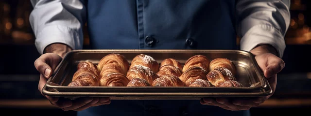 Fotobehang chef holding freshly baked croissants. delicious pastries © Артур Комис