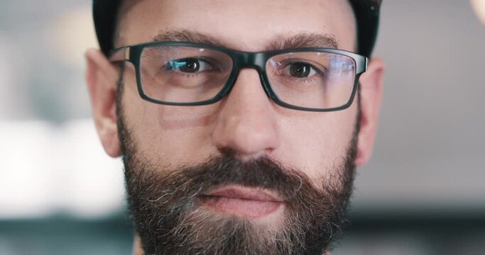 Serious, glasses or face of man, nerd or geek with confidence, eyewear or beard in office. Portrait of smart male person, employee or casual worker looking with spectacles, blank stare or closeup