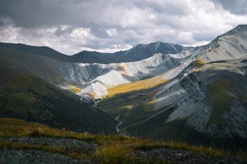 Mountain tourism in Altai, summer landscape with a view from the pass down to the Yarlu valley in the Altai mountains near Mount Belukha, dramatic mountain landscape