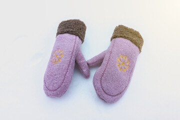 YesNo
Cute pink winter women's mittens on the snow. Clothes for cold weather wearing.
