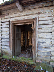 White wooden log house with yellow door