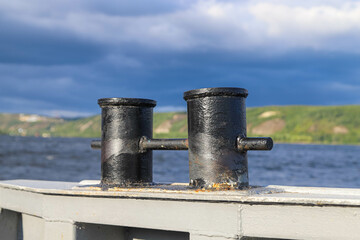 Old rusty double bitt bollard on a river boat