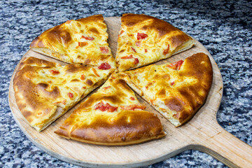 Close-up of delicious slices of Italian pizza on a cutting board.