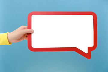 Close up of female hand holding mockup speech bubble for opinion, marketing space or brand...