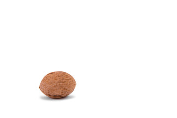 Scattered whole walnuts lie on a white background. Backgrounds and textures. Isolate.