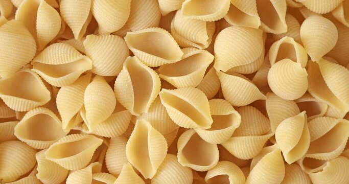 Close-up of dry conchiglie rigate pasta background