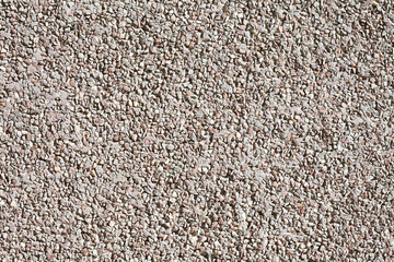 Gray mineral background. Tile adhesive texture. Facade plaster background. Gray plaster grains pattern. Little stones background. Gray noise backdrop. Stone facade texture.