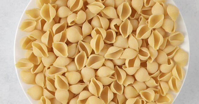 Close-up of dry conchiglie rigate pasta background