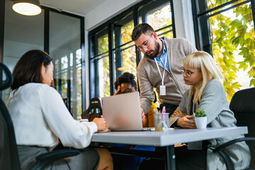 International workers group and team leader having teamwork discussion managing project at work in meeting room.