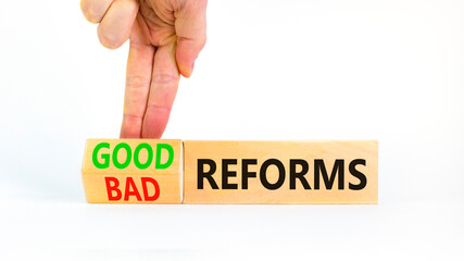 Good or bad reforms symbol. Concept words Good reforms Bad reforms on beautiful wooden blocks. Beautiful white table white background. Businessman hand. Business good bad reforms concept. Copy space