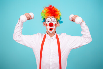 Funny clown and different situations. A happy guy goes in for sports. Blue background.