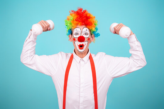 Funny clown and different situations. A happy guy goes in for sports. Blue background.
