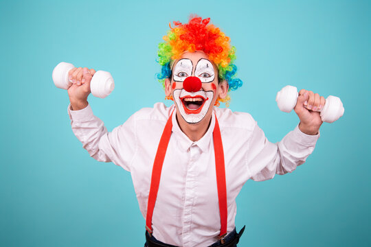 Funny clown and different situations. A happy guy goes in for sports. Blue background.