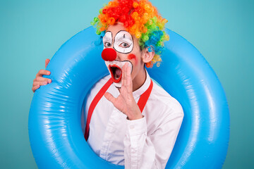 Funny clown and different situations. A happy guy is waiting for a vacation. Blue background.