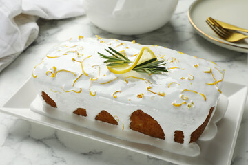 Tasty lemon cake with glaze on white marble table, closeup