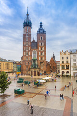 Central market square with historic church and houses in Krakow, Poland