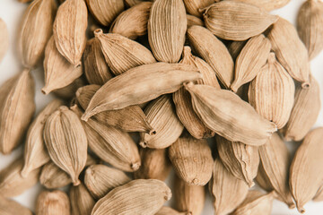 Cardamon seeds on a white background