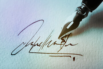 Sheet of paper with fountain pen and signature, closeup