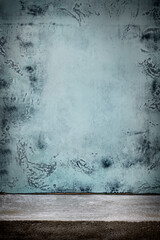 Grungy blue wall with concrete floor