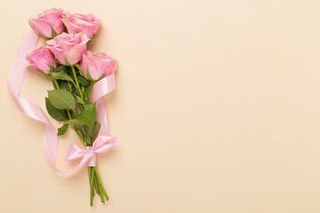 Pink roses on color background, top view. Valentines day concept