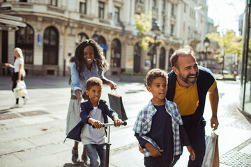 Happy diverse family walking together in urban setting