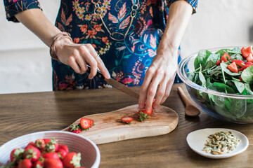 person cutting strawberries
