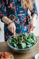 person preparing salad
