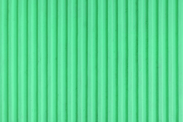 Old pastel green concrete background wall with vertical line ribbed. Stripes as a texture. © Jovana