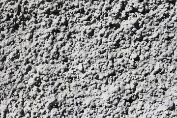 Gray mineral background. Tile adhesive texture. Facade plaster background. Gray plaster grains pattern. Home renovation texture. Granules backdrop. Stucco wall background. Grunge cement texture.	