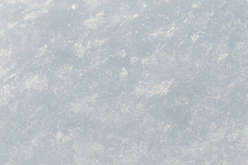 White snow texture with snowflakes, close-up