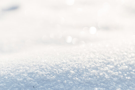 Snowy white field on a sunny day. Space for design and product. Winter and frost background
