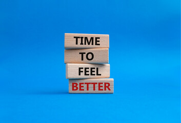 Time to feel better symbol. Wooden blocks with words Time to feel better. Beautiful blue background. Medicine and Time to feel better concept. Copy space.