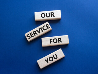 Our service for you symbol. Wooden blocks with words Our service for you. Beautiful deep blue background. Business and Our service for you concept. Copy space.