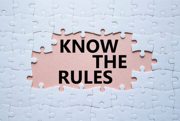 Know the rules symbol. Concept words Know the rules on white puzzle. Beautiful pink background....