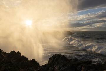 Splashing water from crashing waves on spanish coastline in the north of Spain in Asturias at...