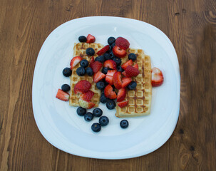 Close-up delicious pancakes, with fresh blueberries, strawberries