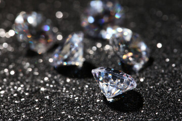 Many beautiful diamonds on dark shiny background, closeup