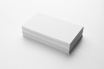 Stack of blank business cards on white table. Mockup for design