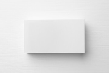 Stack of blank business cards on white table, top view. Mockup for design