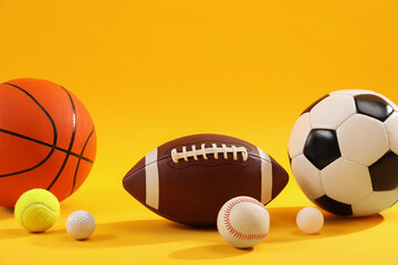 Many different sports balls on yellow background, space for text