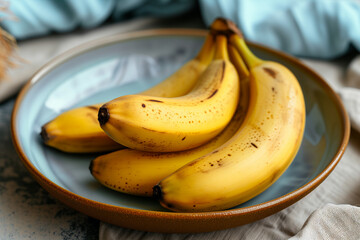 bananas in a bowl. Fresh and sweet banana. Fruits for fitness. Wooden plate with yellow fruits....