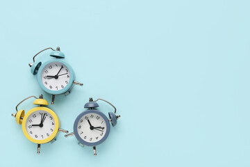 Alarm clocks on blue background