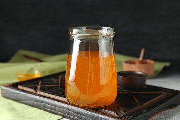 Jar of sweet honey on table