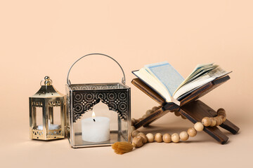 Muslim lamps with prayer beads and Koran on beige background