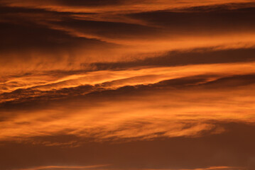 Fototapeta na wymiar Beautiful fiery orange sky and clouds after the sunset